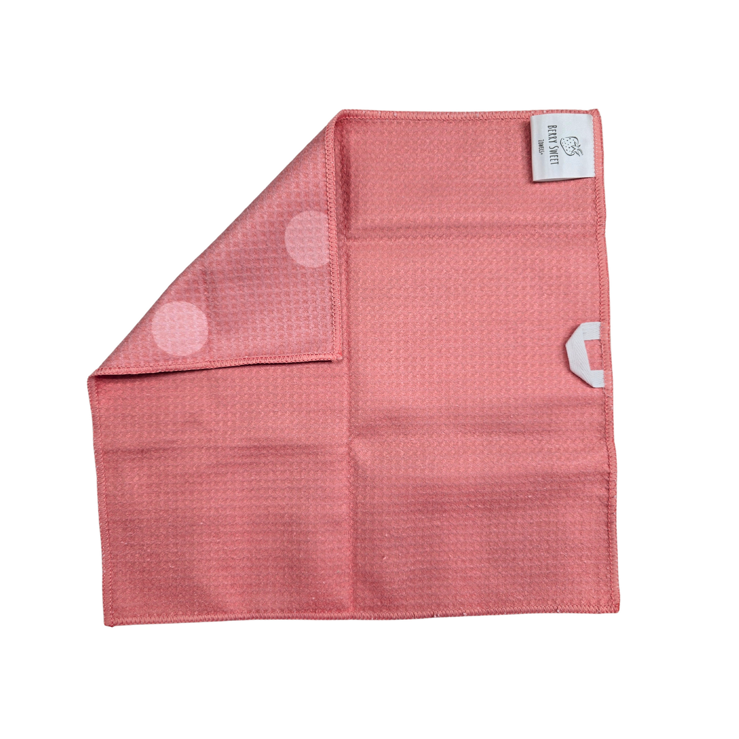 Solid Pink waffle-weave microfiber washcloth, shown with a corner folded over to reveal the pink front with light pink polkadots.