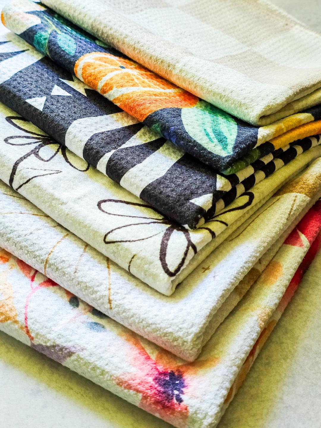 asthetic view of six microfiber hand towels folded and placed neatly showing just the corner and sides. 