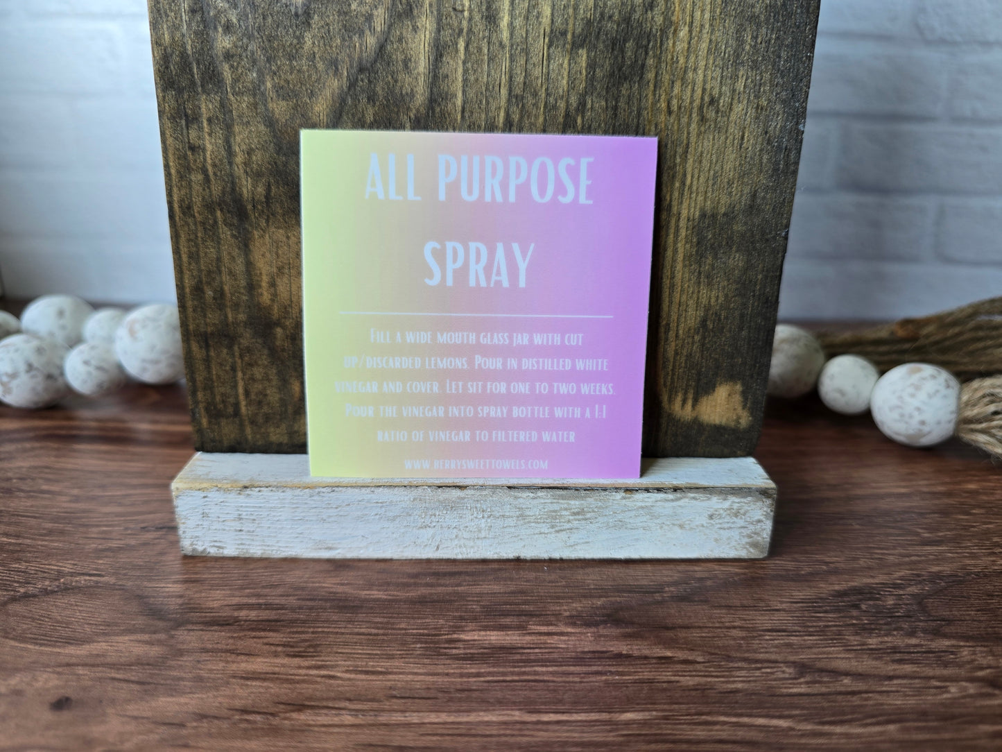 Square vinyl sticker with white text on a yellow and pink background labeled “All Purpose Spray,” featuring instructions for a citrus-infused vinegar cleaning spray with a 1:1 vinegar to filtered water ratio.