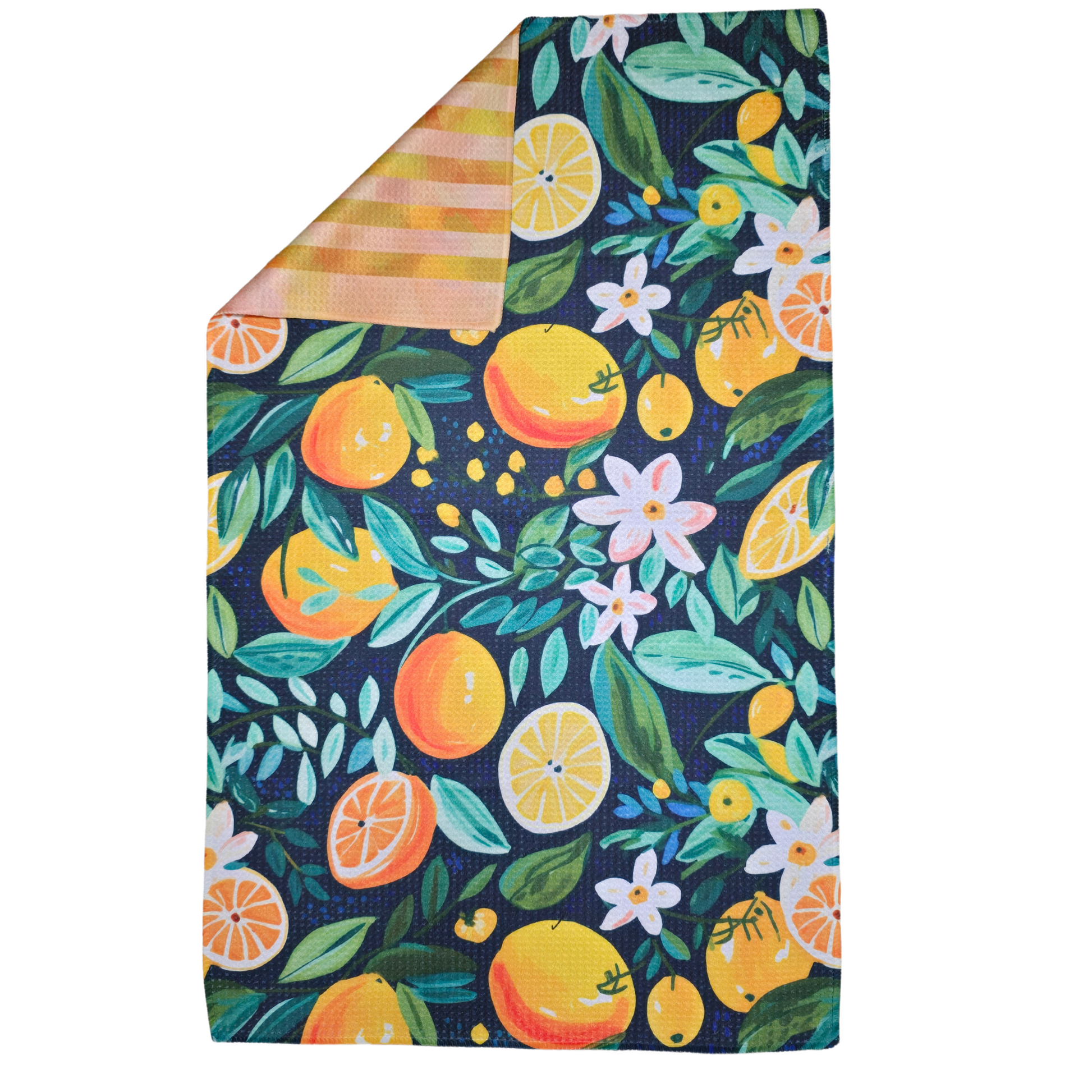Double-sided waffle weave microfiber hand towel laid flat, featuring a navy background with illustrated oranges, lemons, green leaves, and white flowers, with a folded corner revealing the orange and yellow striped reverse side.
