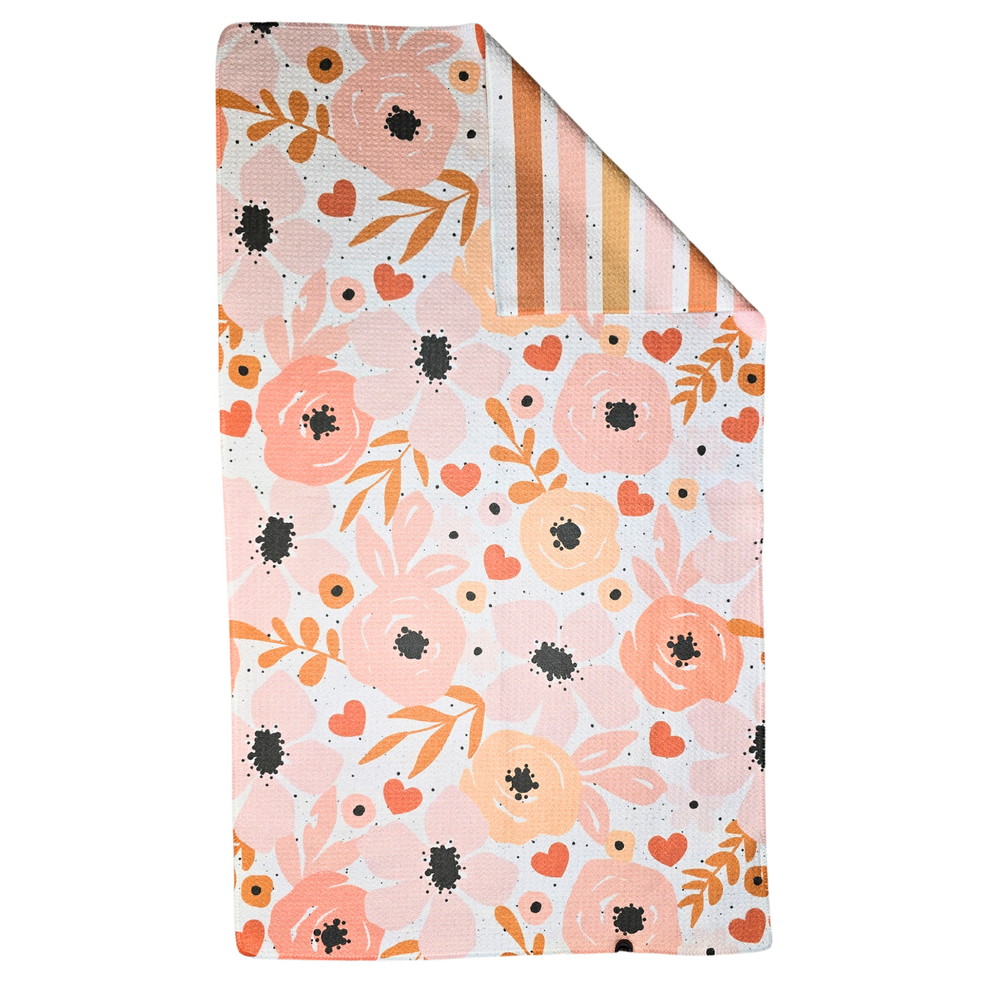 Double-sided waffle weave microfiber hand towel laid flat with one corner folded back, showing a floral design in pink, coral, and peach with black splatter on the front and a striped multicolored pattern with black splatter on the reverse.