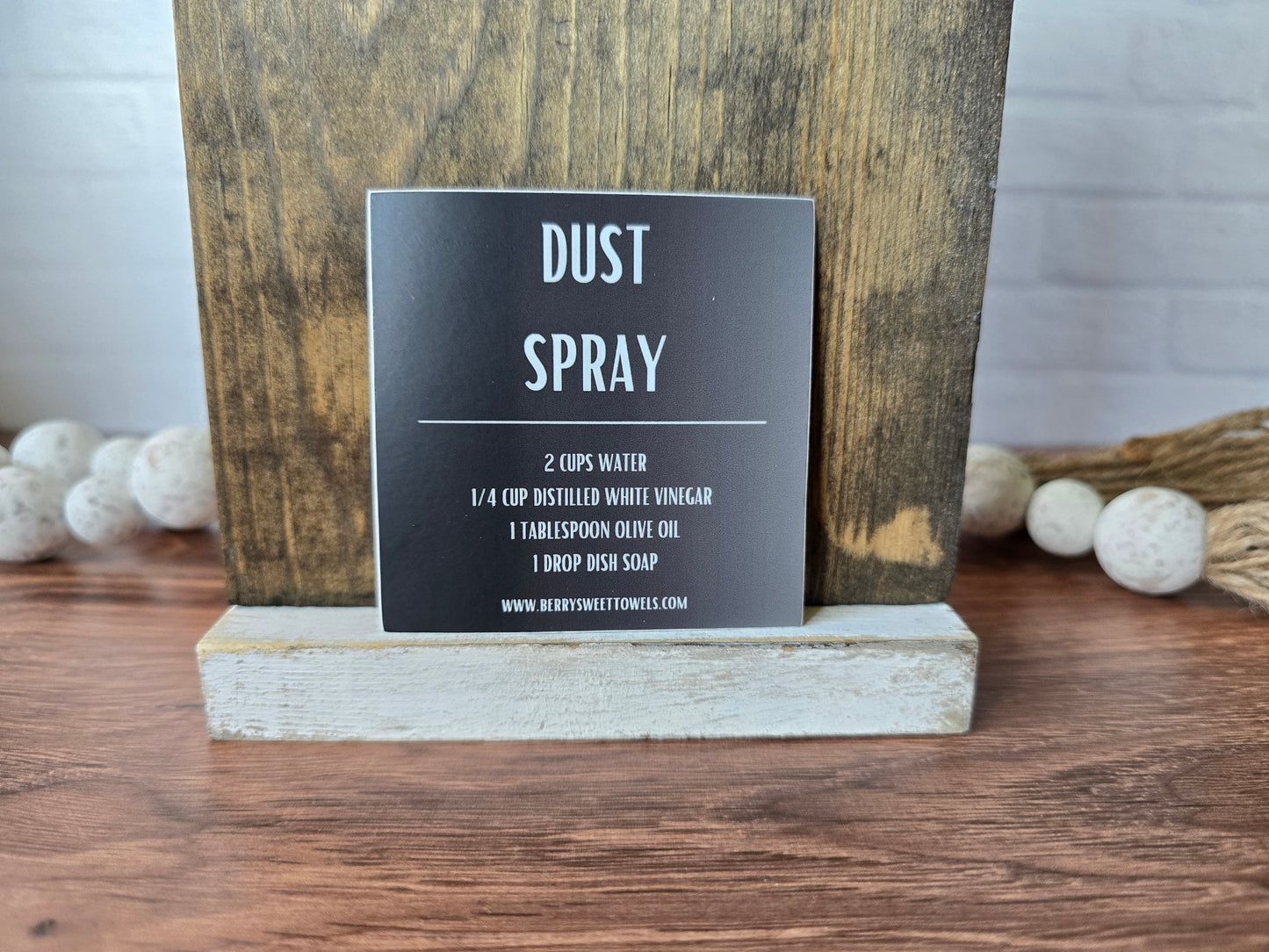 Square vinyl sticker with a black background and white text labeled “Dust Spray,” displaying a DIY recipe using water, distilled white vinegar, olive oil, and dish soap.
