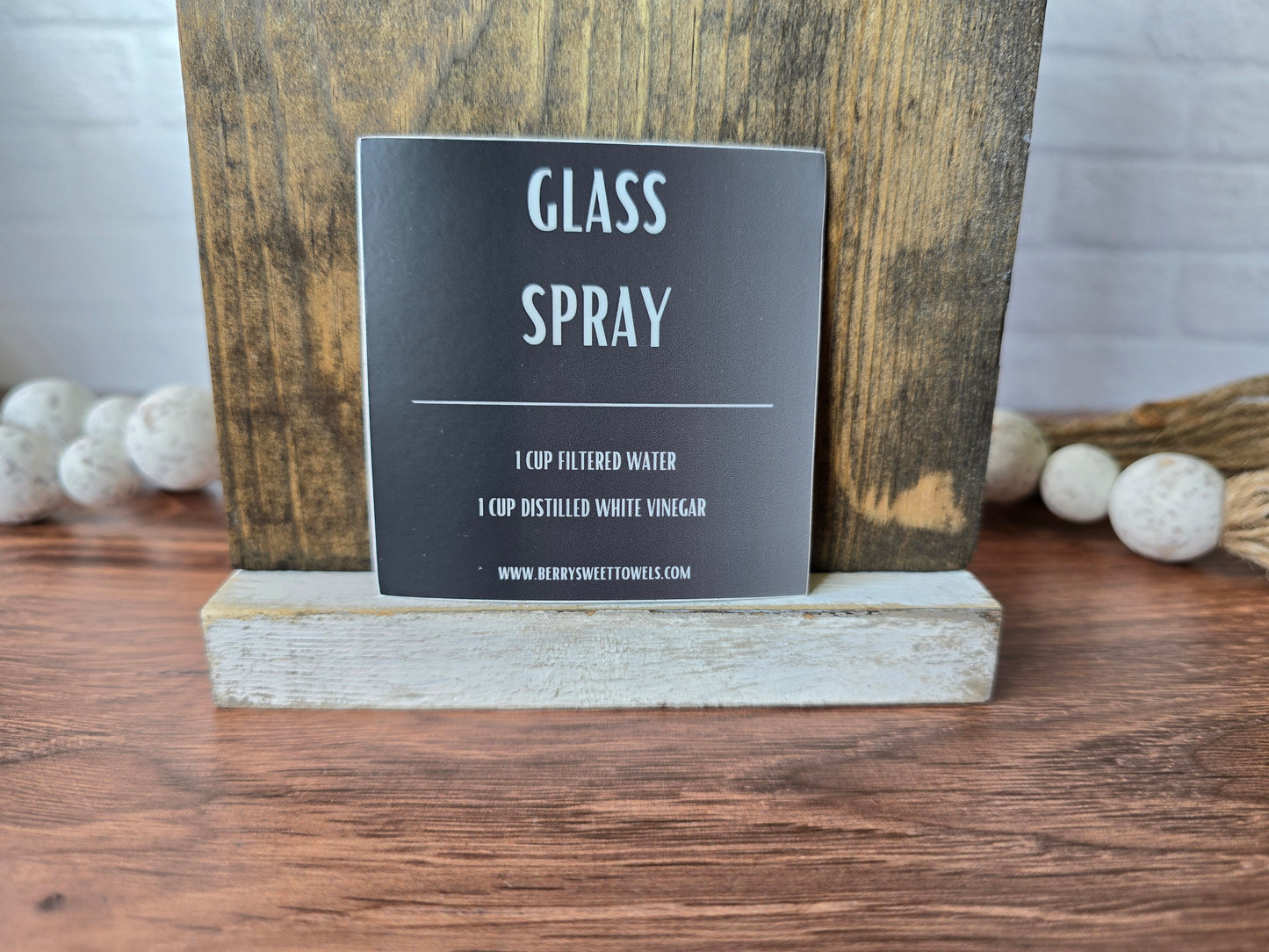 Square vinyl sticker with white text on a black background labeled “Glass Spray,” featuring a DIY recipe using 1 cup filtered water and 1 cup distilled white vinegar.