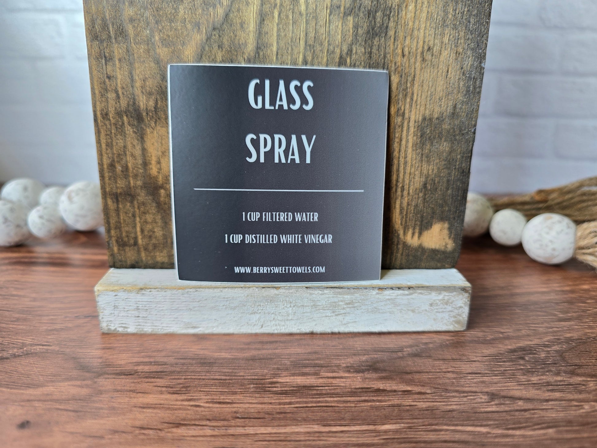 Square vinyl sticker with white text on a black background labeled “Glass Spray,” featuring a DIY recipe using 1 cup filtered water and 1 cup distilled white vinegar.