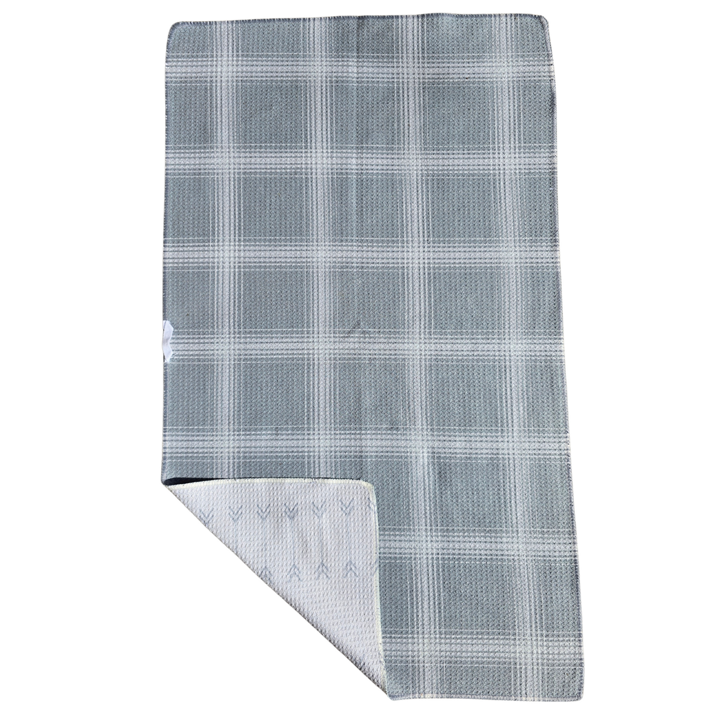 Full view of a waffle weave microfiber hand towel with gray and cream plaid patterned side up and folded corner revealing the cream background with gray arrow patterned reverse side.