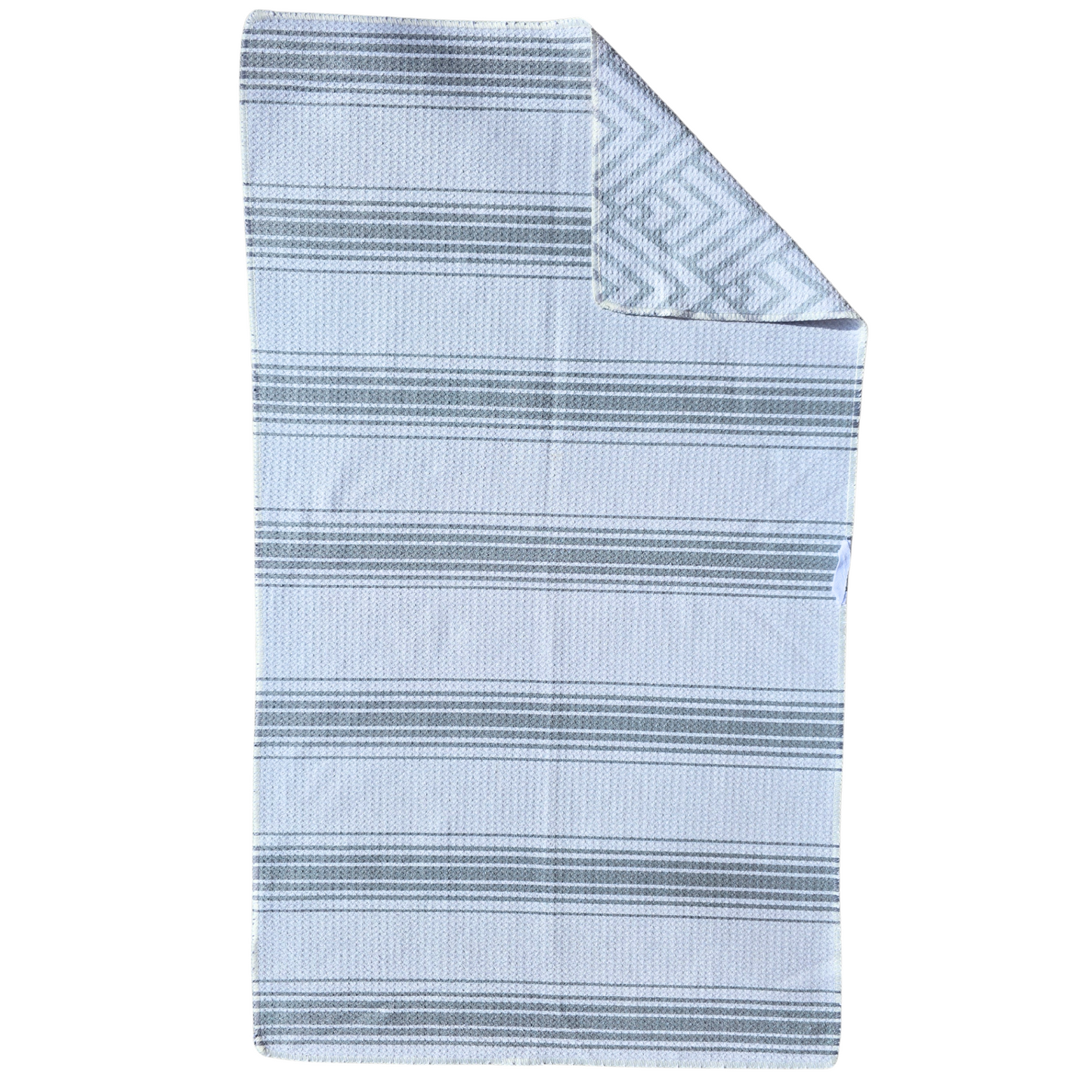Full view of a waffle weave microfiber hand towel with white and gray striped pattern and folded corner showing the light gray and white geometric reverse side.