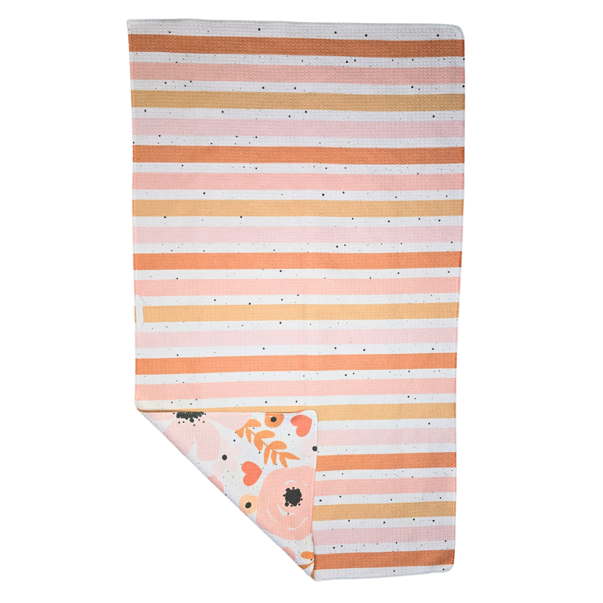 Back view of a microfiber hand towel featuring horizontal stripes in peach, coral, and white, with a black splatter with a folded corner revealing the floral patterned and black splattered front.