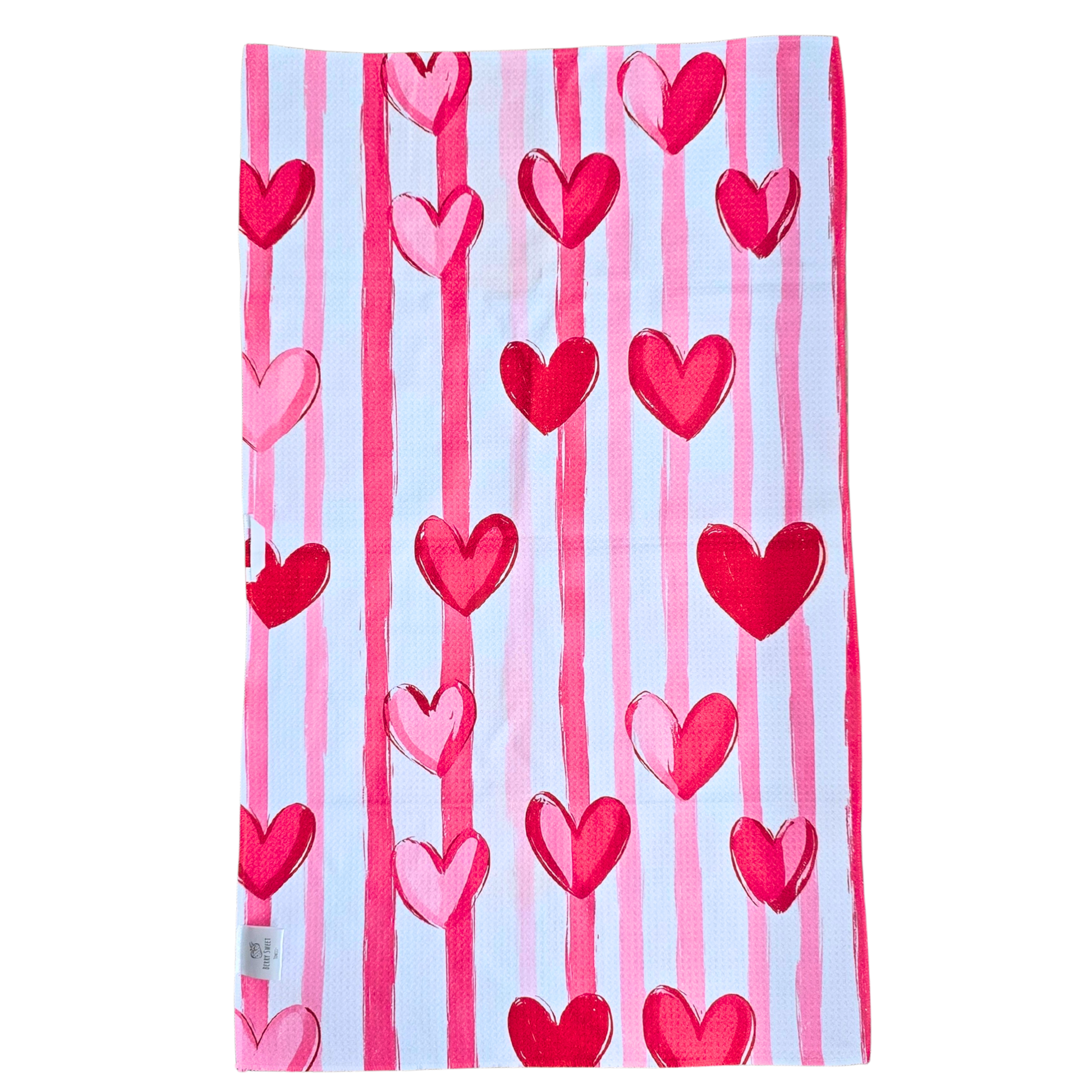 Full view of the reverse side of a waffle weave microfiber hand towel with vertical light pink, dark pink, and white stripes accented by red and pink heart designs.