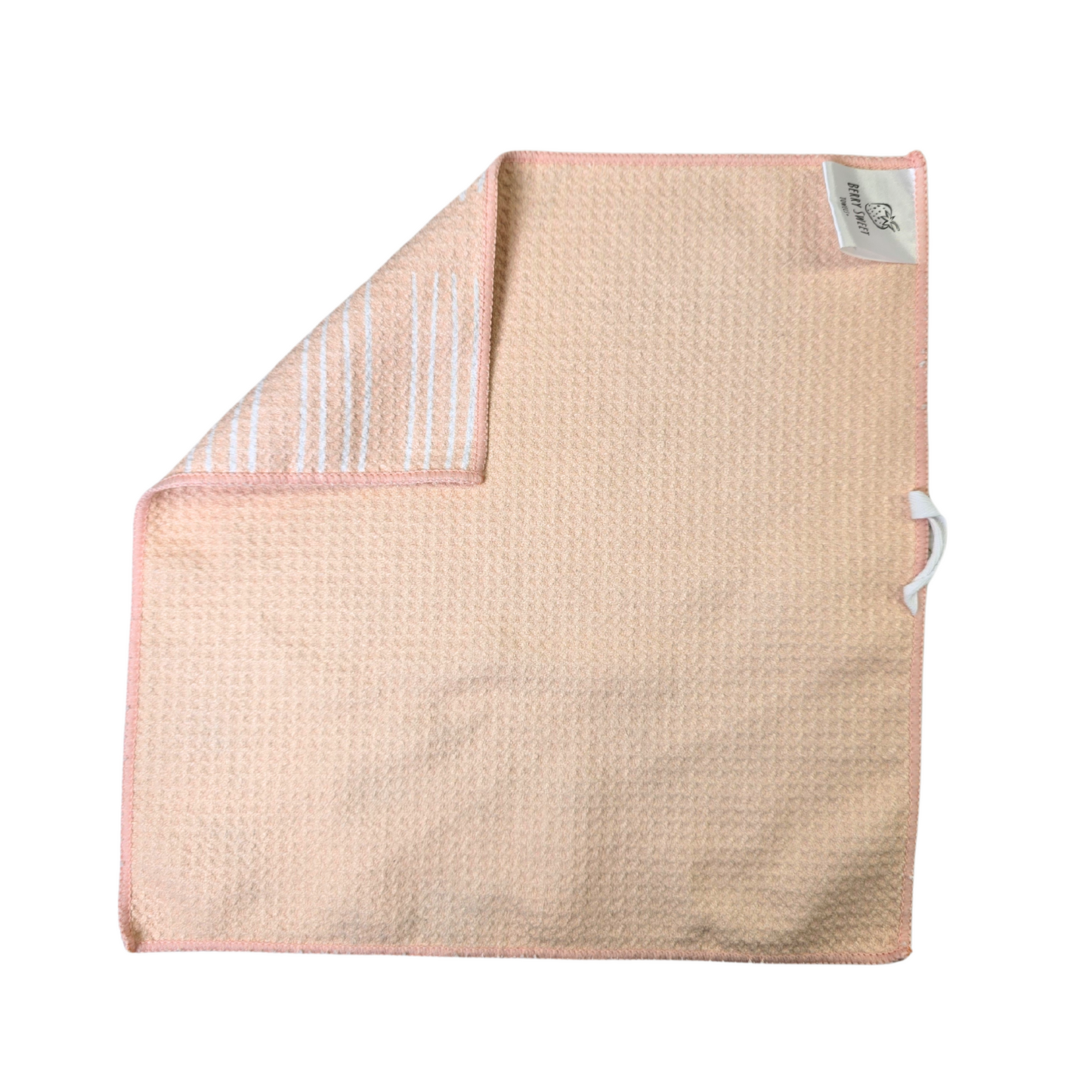 Soft-yellow waffle weave microfiber washcloth laid flat showing the solid reverse side with a corner folded to show the white striped front.