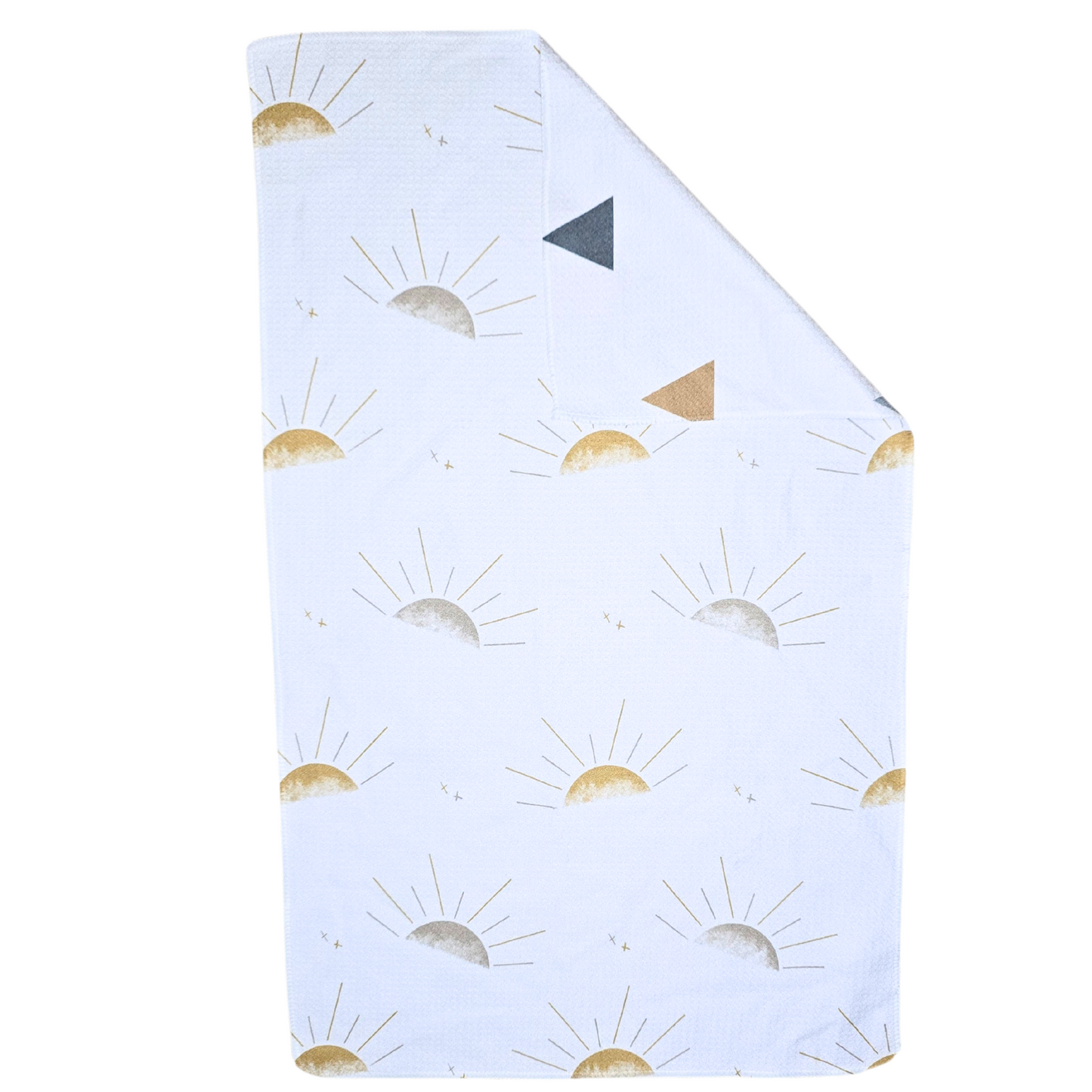 Double-sided microfiber hand towel laid flat, featuring a white front with repeating sunburst motifs in soft gold and gray tones with a corner folded to show the reverse white side featuring multi-colored triangles. 